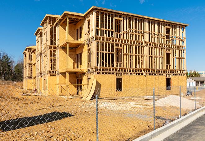 a close-up of temporary chain link fences enclosing a construction site, signaling progress in the project's development in Mount Prospect